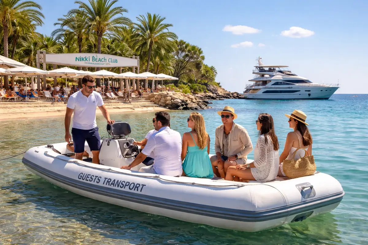 Dinghy picking up guests from Nikki Beach Mallorca to a private catamaran during a day trip Real Yacht Charter